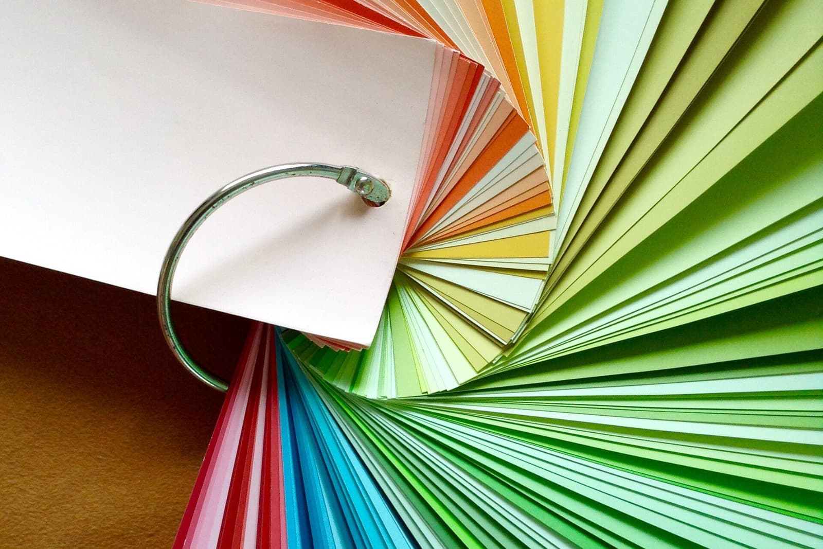 Fanned-out paint color swatch deck in a rainbow of hues used during a color consultation