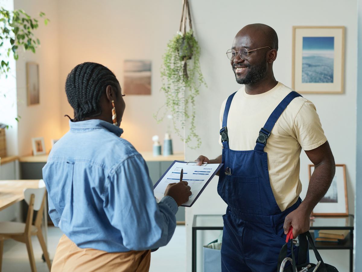 Homeowner and painter reviewing paperwork together